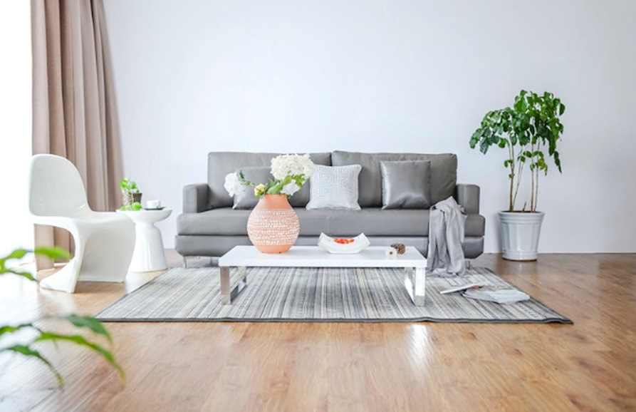 Sustainable flooring. Image shows sofa, chair, plants and coffee table on high quality flooring