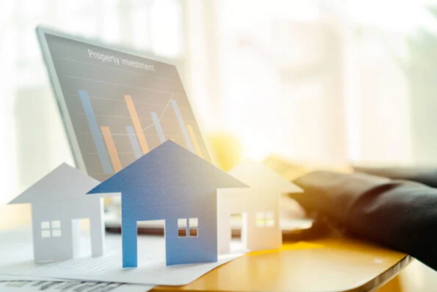 Property Investor - hands at laptop, cut out houses.
Credit: Shutterstock - scaled